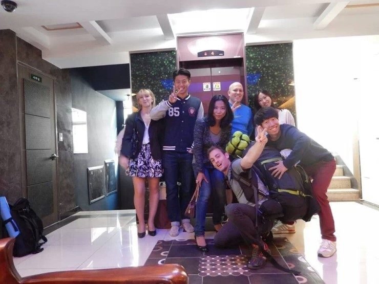 Guests together in a guesthouse lobby by the front desk