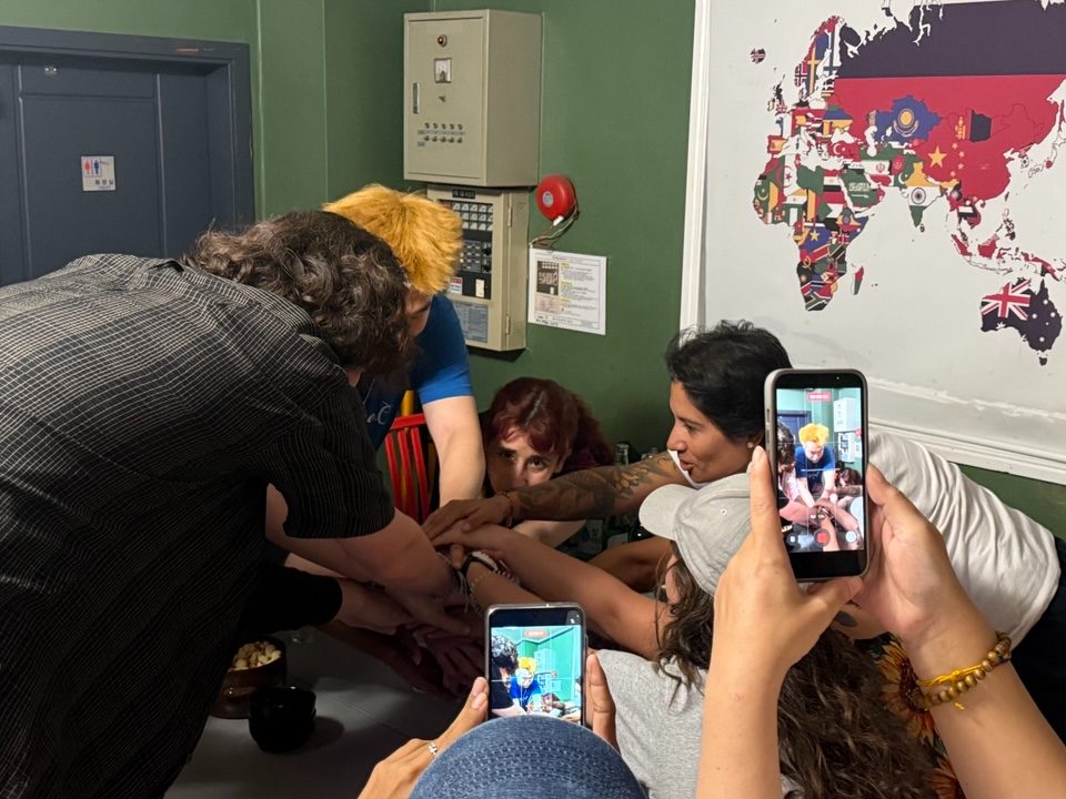 Guests playing a game together in a dormitory room